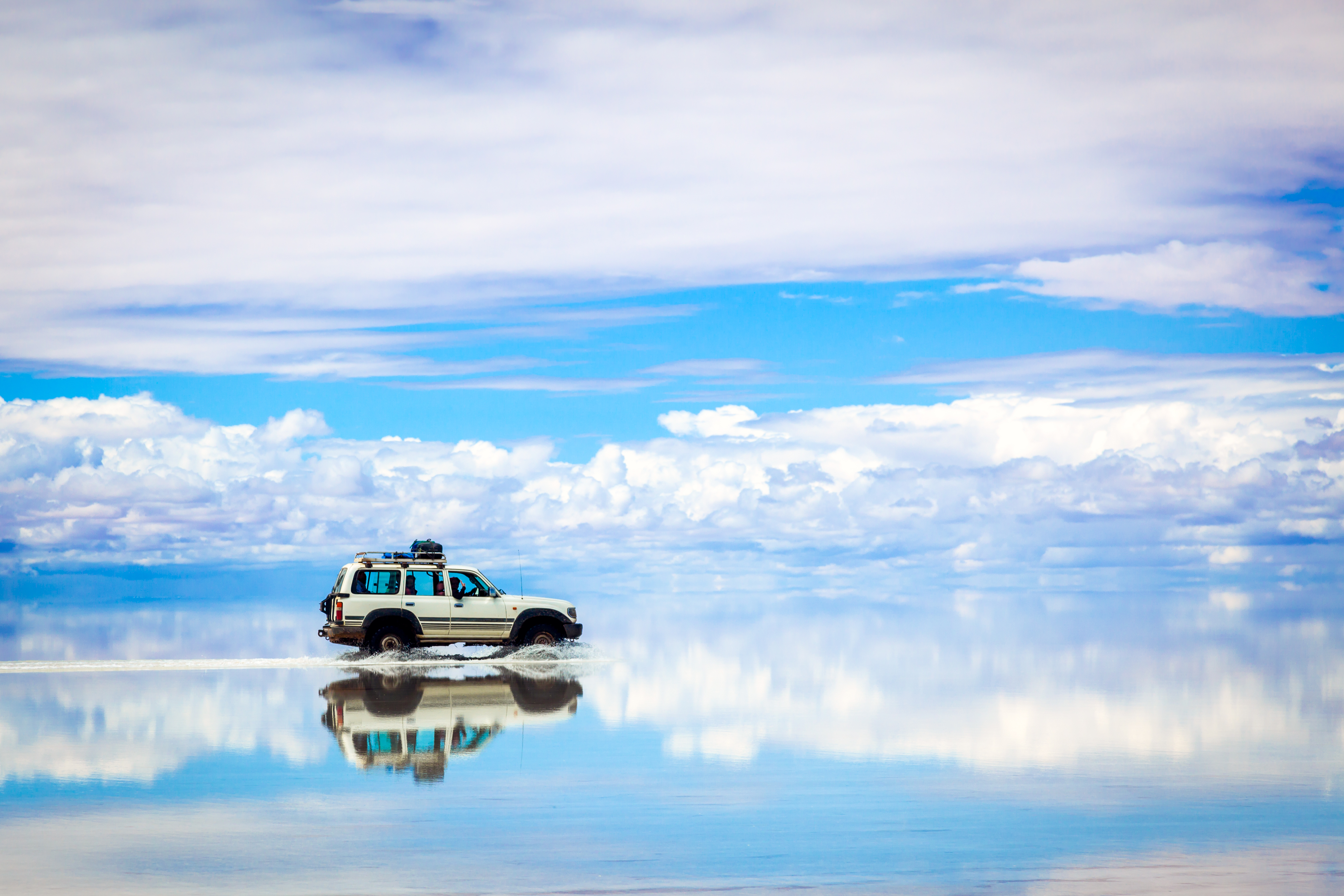 Sports Utility Vehicle driving in the Salar de Uyuni, Bolivia