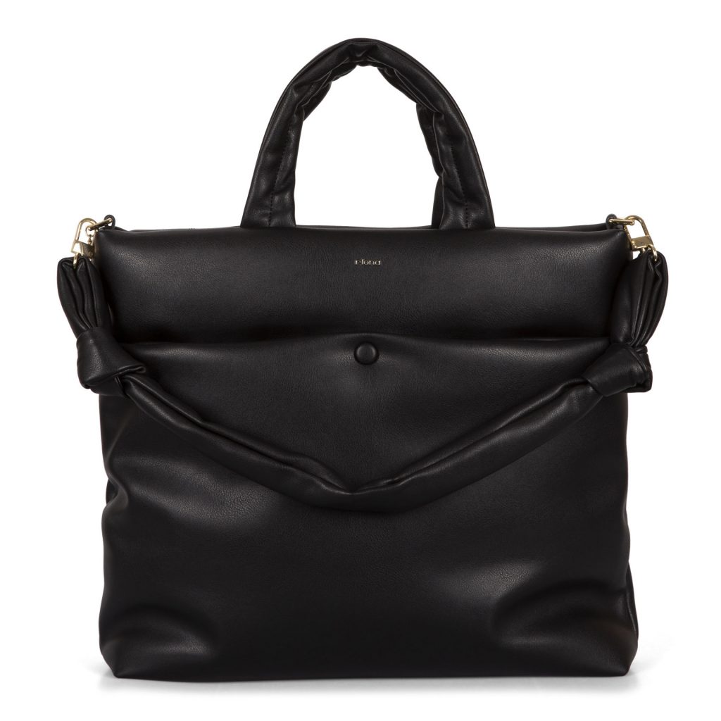 A black trending Riona vegan fall handbag called Casie showing its pillowy vegan texture, a knotted strap, and a top handles.