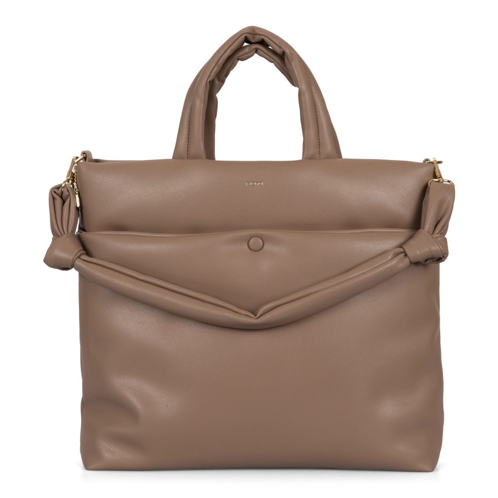 Beige trending Riona vegan fall handbag called Casie designed by Riona showing its pillowy vegan texture, a knotted strap, and a top handles.